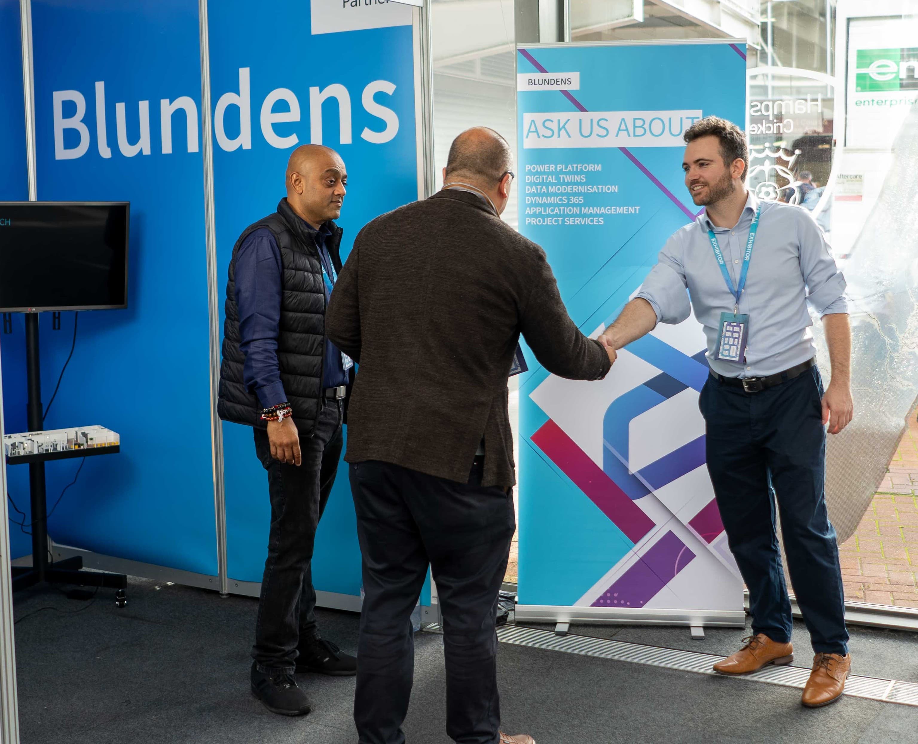 The Blundens team welcoming a visitor to its exhibition stand